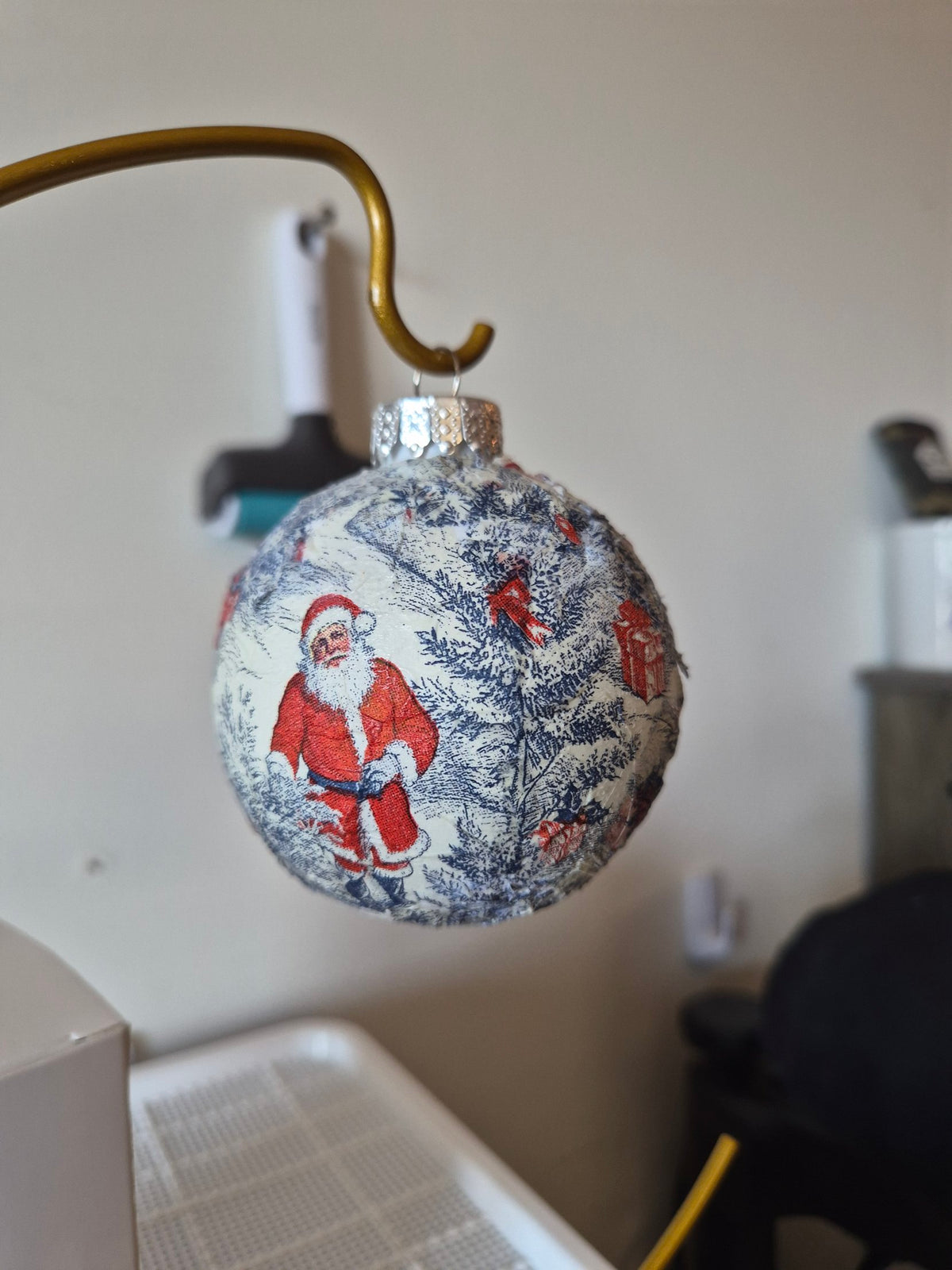 Real photo of the Blue Santa toile ornament showing Santa and evergreens