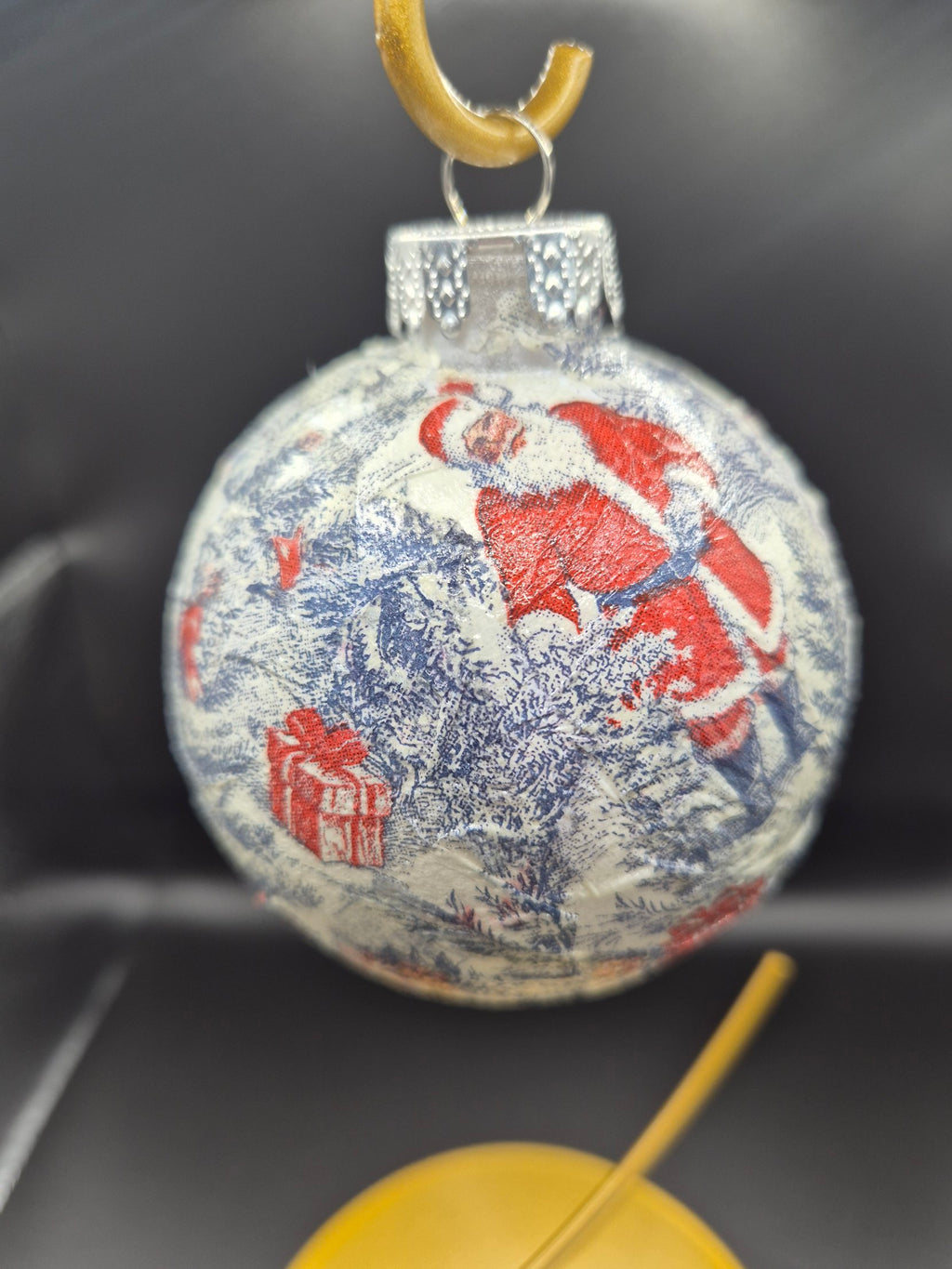 Real photo of the Blue Santa toile ornament showing red gifts