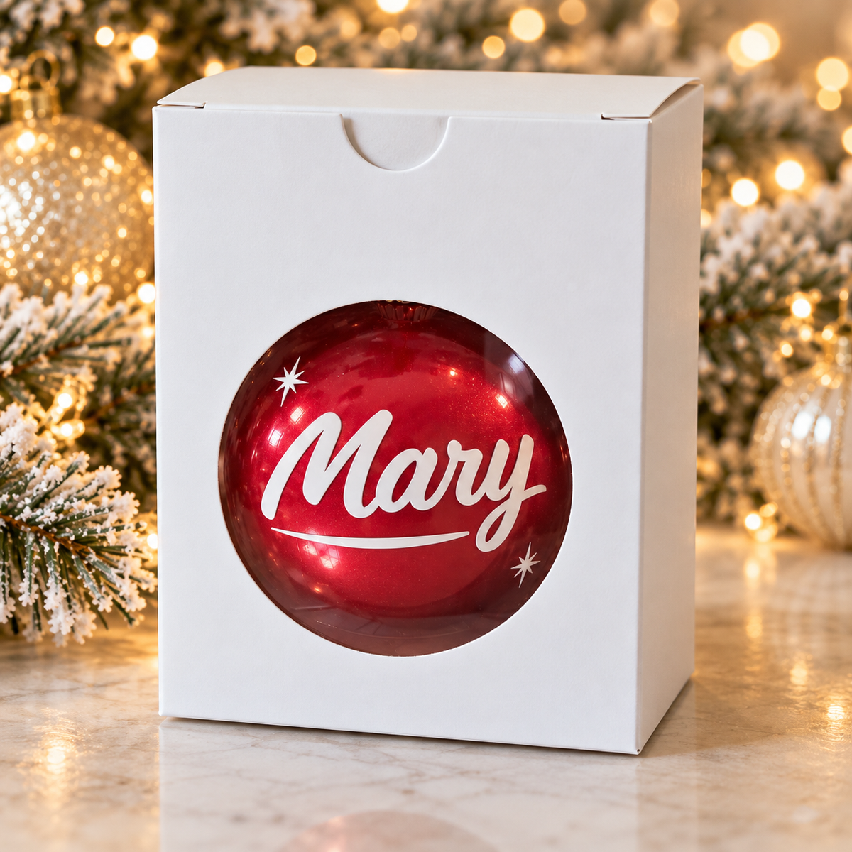 Personalized red name ornament in a white gift box with a window